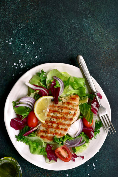 istock Grilled chicken or turkey breast with fresh vegetable salad 1124837831