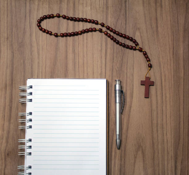 istock Blank notebook on wooden table with wooden rosary 1124840243