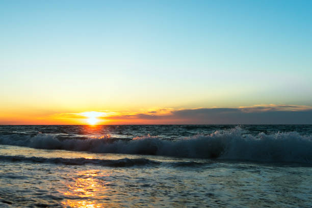 istock Sunset on the seashore. Coastal waves. Clouds on the horizon. Beautiful landscape. 1124848925