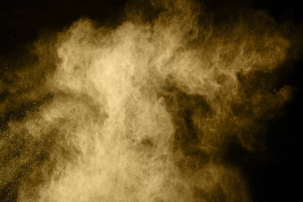 istock Golden powder explosion on black background. Freeze motion. 1124852665