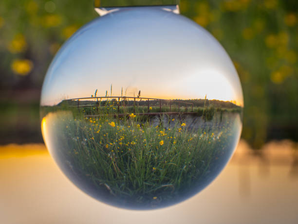 istock Sunrise on meadow in the glass ball 1124856308