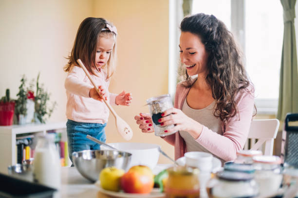 istock Happy mother and daughter in kitchen 1124856656