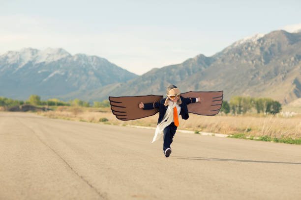 istock Young Business Boy with Cardboard Wings 1124857317