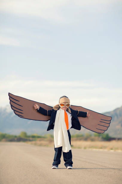 istock Young Business Boy with Cardboard Wings 1124857318