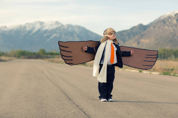istock Young Business Boy with Cardboard Wings 1124857320