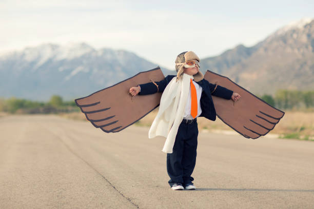 istock Young Business Boy with Cardboard Wings 1124857322