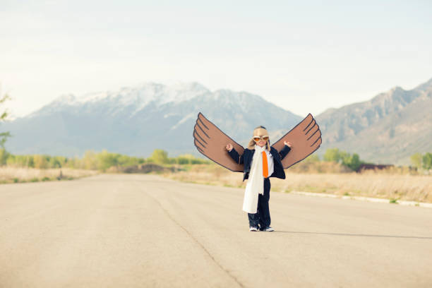 istock Young Business Boy with Cardboard Wings 1124857324