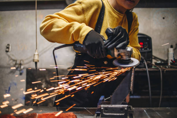 istock Hard working girl using a grinder on metal 1124858013