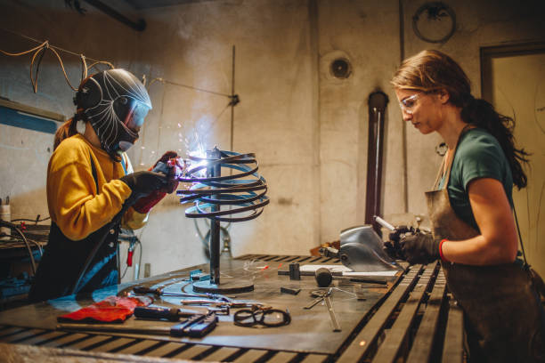 istock Focused young women in a welding workshop 1124859749