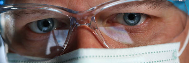 istock Handsome male physician face wearing protective mask 1124867110