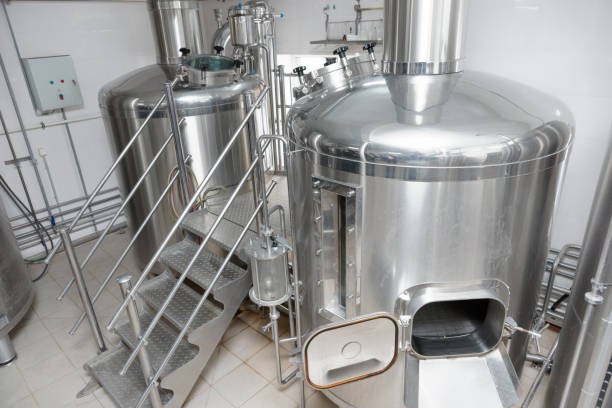 Two mash-tubs on beer-making plant Two mash vats used to mix and boil malt, beer-making plant mixing vat stock pictures, royalty-free photos & images