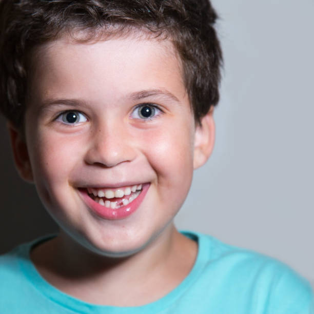 istock Boy lost baby tooth 1124870214