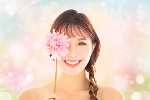 istock young smiling beauty face with spring background 1124881858
