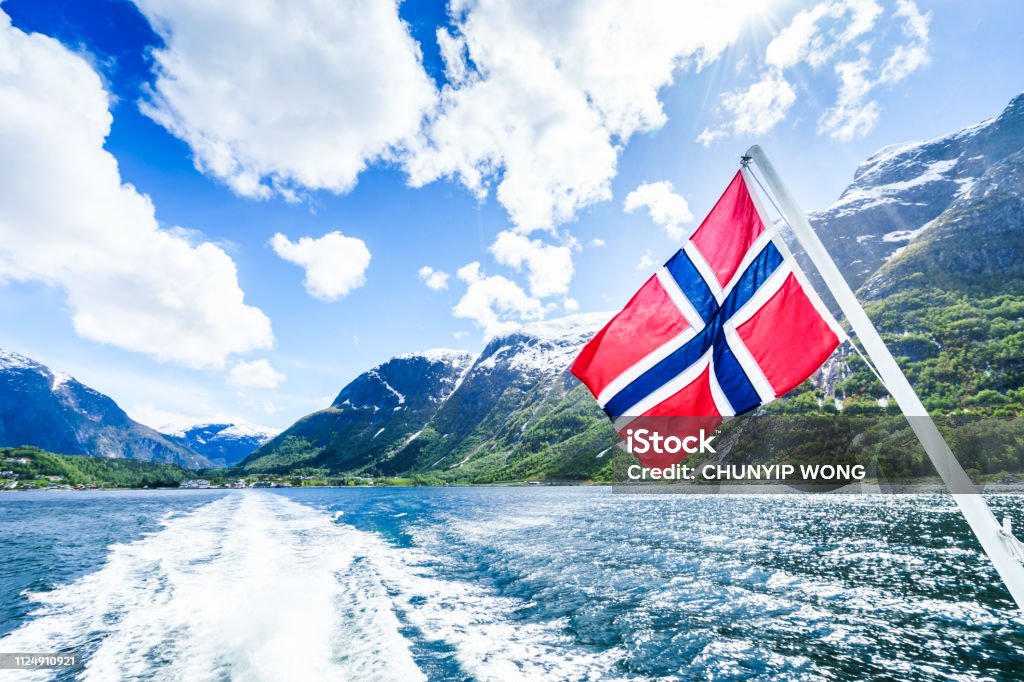 Norwegian Flag with beautiful background Bergen - Norway, Europe, Nordic Countries, Northern Europe, Norway Norwegian Flag Stock Photo