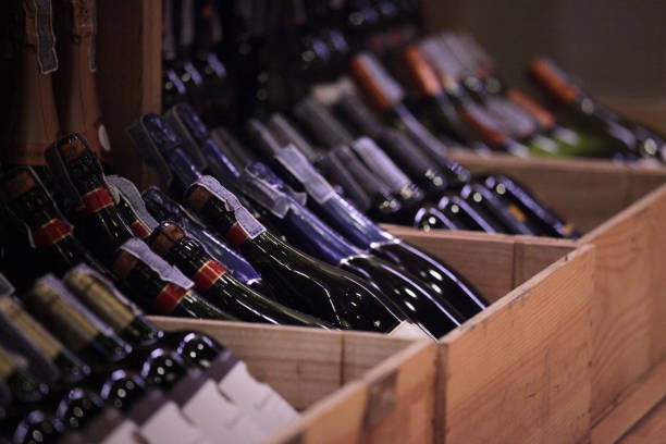 variety of wine in crates at retail shop - garrafa vinho imagens e fotografias de stock