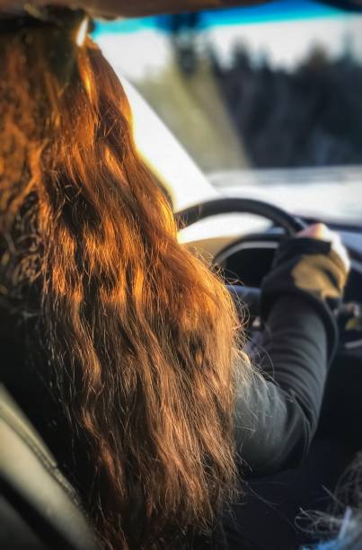 istock Teenager driving safely, with sun and window view 1124920918