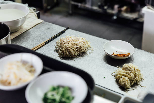 istock Raw Hakata style ramen noodle with chashu pork on kitchen counter. Prepare for cooking ramen. 1124921022