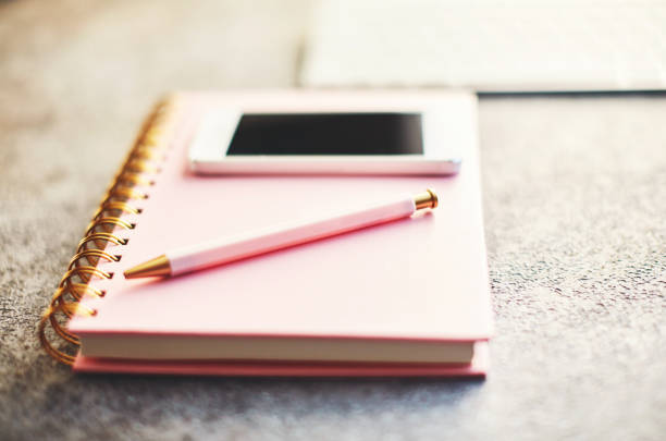 istock Bloggers desk with phone, keyboard and accessories 1124928706