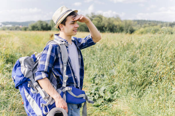 istock young traveler guy hiking with backpack in the nature 1124934225