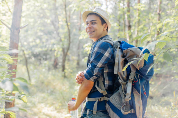 istock young traveler guy hiking with backpack in the nature 1124935425