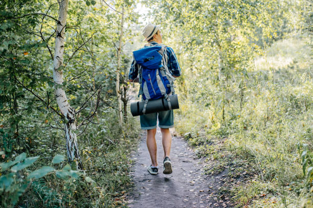 istock young traveler guy hiking with backpack in the nature 1124935470
