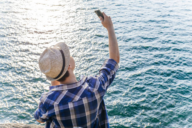 istock Handsome smiling hiker guy is taking a selfie photo 1124935597