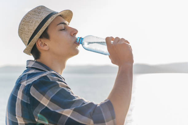 istock male hiker taking a break and drinking water from bottle 1124935690