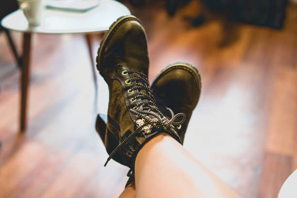 istock Close Up on Womans Feet in Boots resting on chair 1124943039