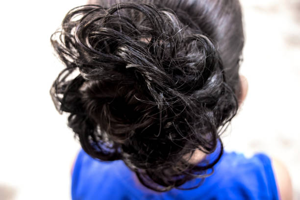istock hairstyle bun on the brunette on isolated light background 1124945782