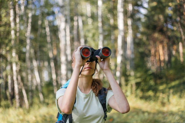 istock Hiker girl is looking in binoculars enjoying spectacular view 1124949708