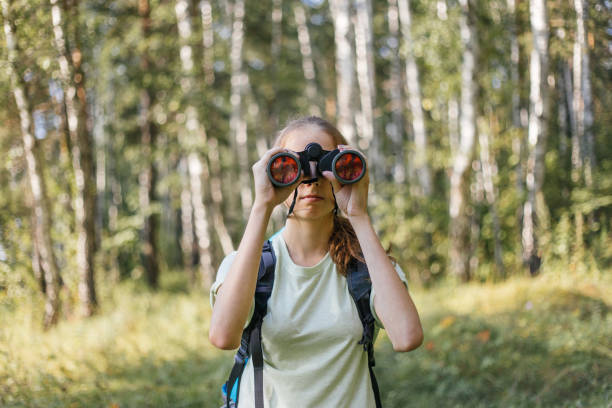 istock Hiker girl is looking in binoculars enjoying spectacular view 1124949736