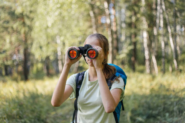 istock Hiker girl is looking in binoculars enjoying spectacular view 1124949743