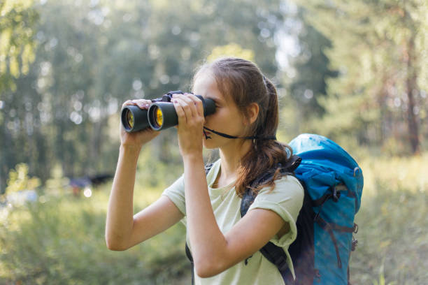 istock Hiker girl is looking in binoculars enjoying spectacular view 1124949745