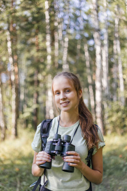 istock Hiker girl is looking in binoculars enjoying spectacular view 1124949765