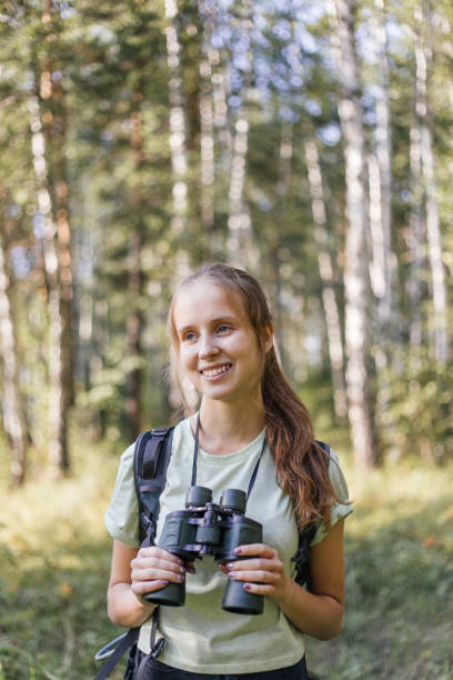 istock Hiker girl is looking in binoculars enjoying spectacular view 1124949769