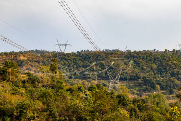 High voltage tower, electric transmission tower in hill area. Electricity distribution tower on top of hill