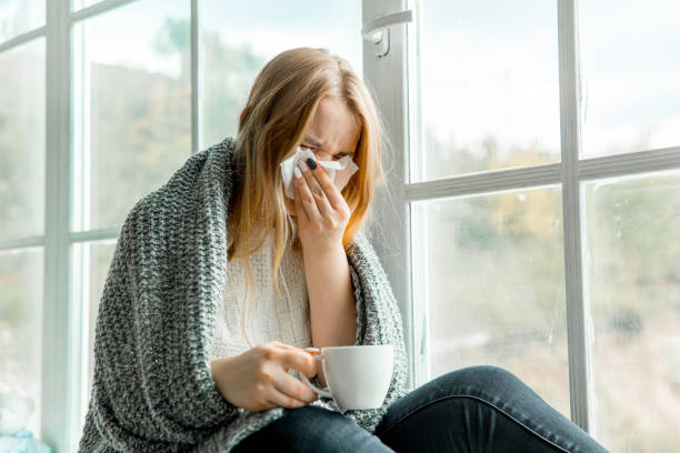 istock Sick young woman with cold and flu at home 1124957847