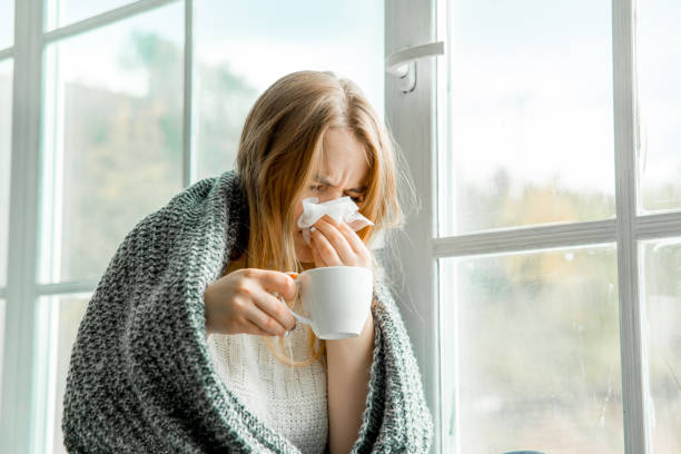 istock Sick young woman with cold and flu at home 1124957858