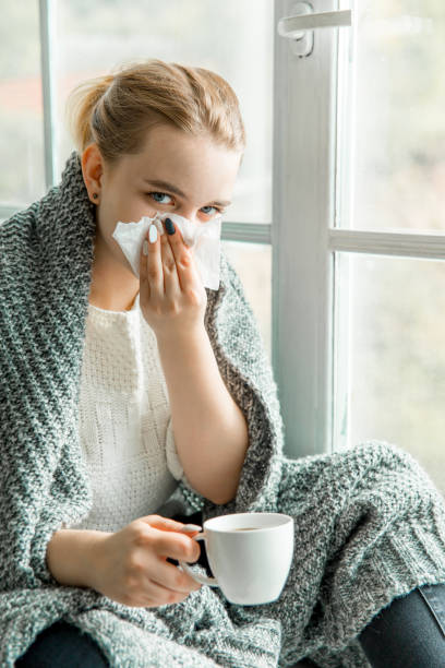 istock Sick young woman with cold and flu at home 1124957875