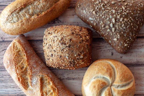 istock Various Baked Breads on Wooden Cutting Board 1124959873