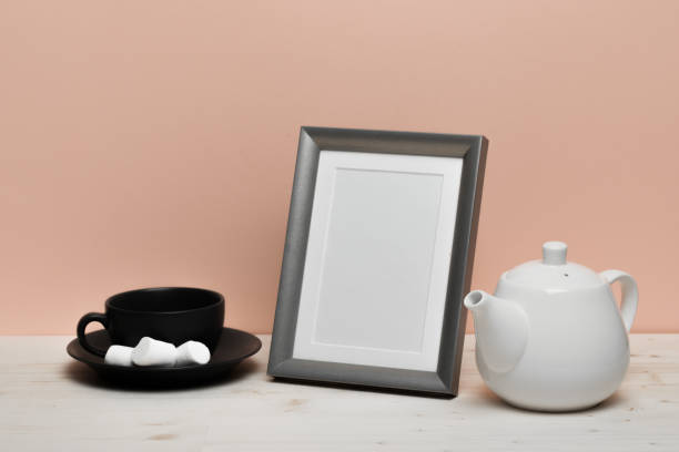 istock silver frame with mug and teapot on white desk near pink wall 1124963284