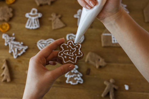 istock Christmas gingerbread icing decorating process. Homemade sweet cookies 1124970180