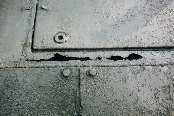 istock Old green peeling paint on the armored fighting vehicle. Rusty dye background texture. 1124978353