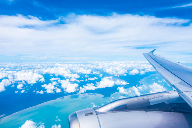 istock Aerial view of airplane wing with blue sky 1124979026