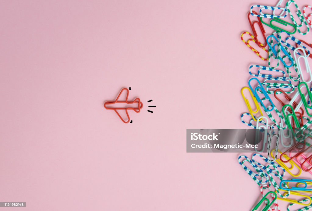 Business concept for group of stacked paperclip with another one red plane paperclip is point to another direction as a team leadership Individuality Stock Photo