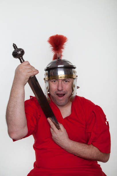 istock A roman soldier with with a sword on the white background. 1124982893