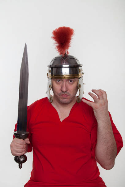 istock A roman soldier with with a sword on the white background. 1124982946