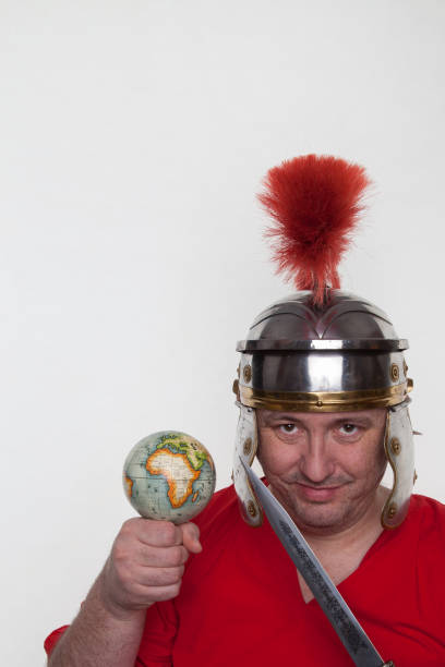istock A roman soldier with a globe and dagger on the white background. 1124983081