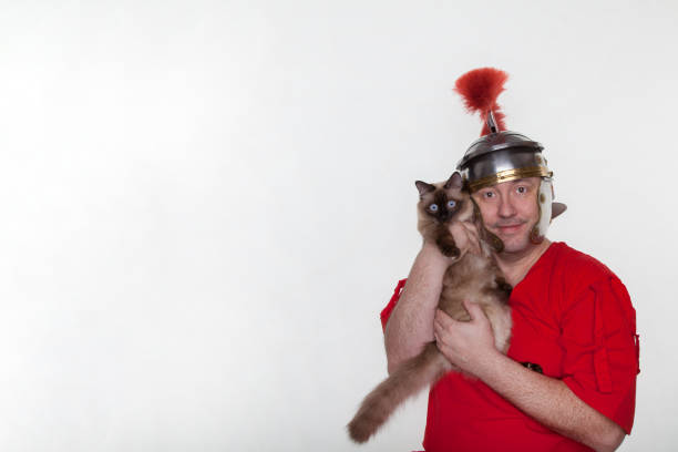 istock A roman soldier with a siamese cat on the white background. 1124983706