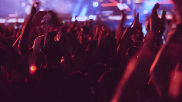 istock abstract colorful background audience in public concert. 1124984447